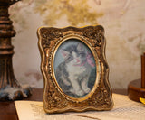 cat in a  glod vintageframe 